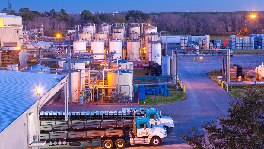 Flatbed trucks at a plant in Fresno, Texas