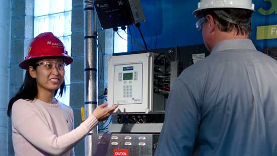 Nalco Water expert showing product's capabilities to Ecolab expert.
